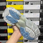Blue and white sneaker outsole with tread pattern and traction grooves