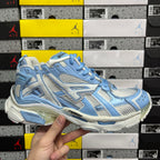 Blue and white lace-up athletic sneaker with textured panels and chunky sole
