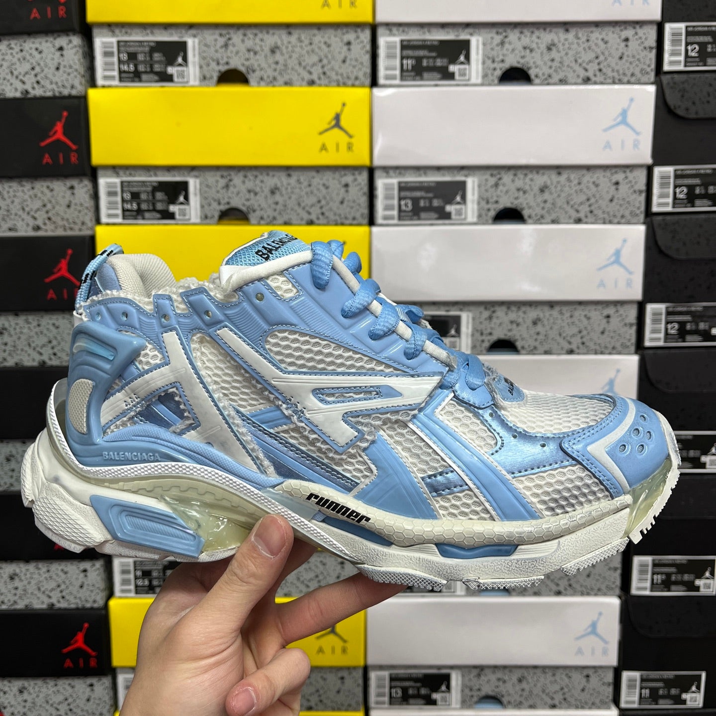 Blue and white lace-up athletic sneaker with textured panels and chunky sole
