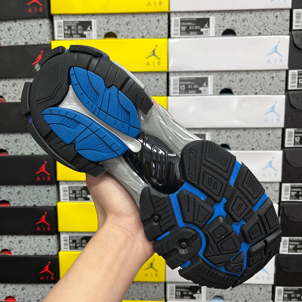 Unisex sneaker outsole, dark tread with blue sections and silver-gray midsole