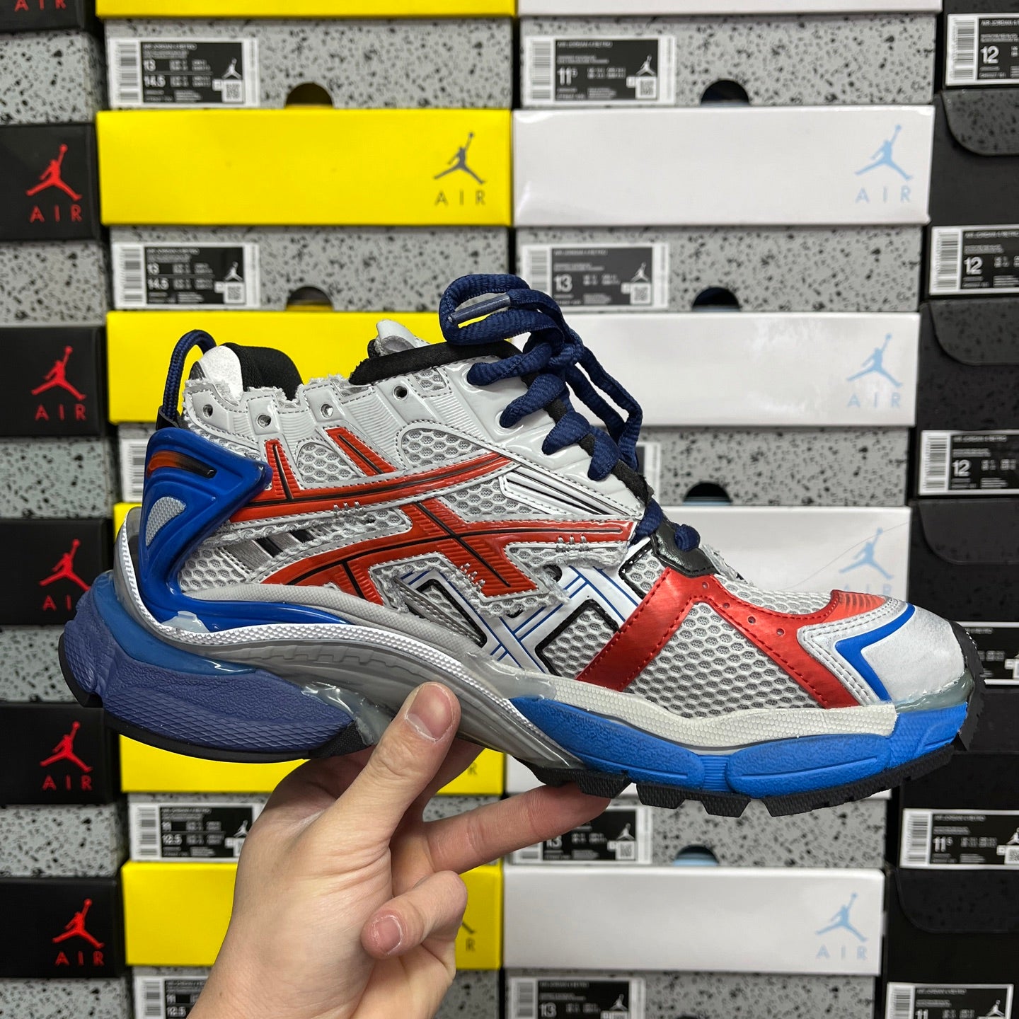 Unisex sneakers front angle, white mesh with red panels and blue laces