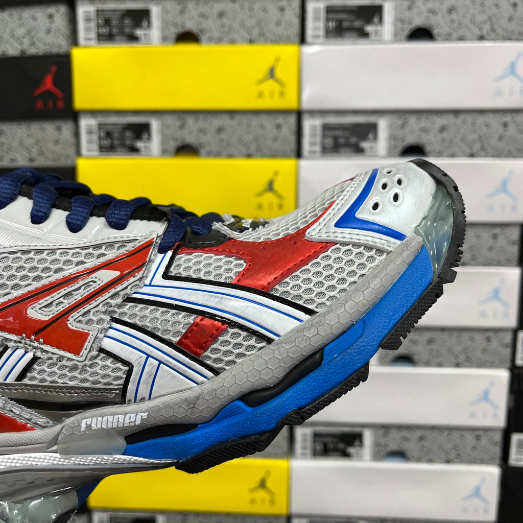 Unisex sneakers side close-up, white mesh with red stripe and blue trim