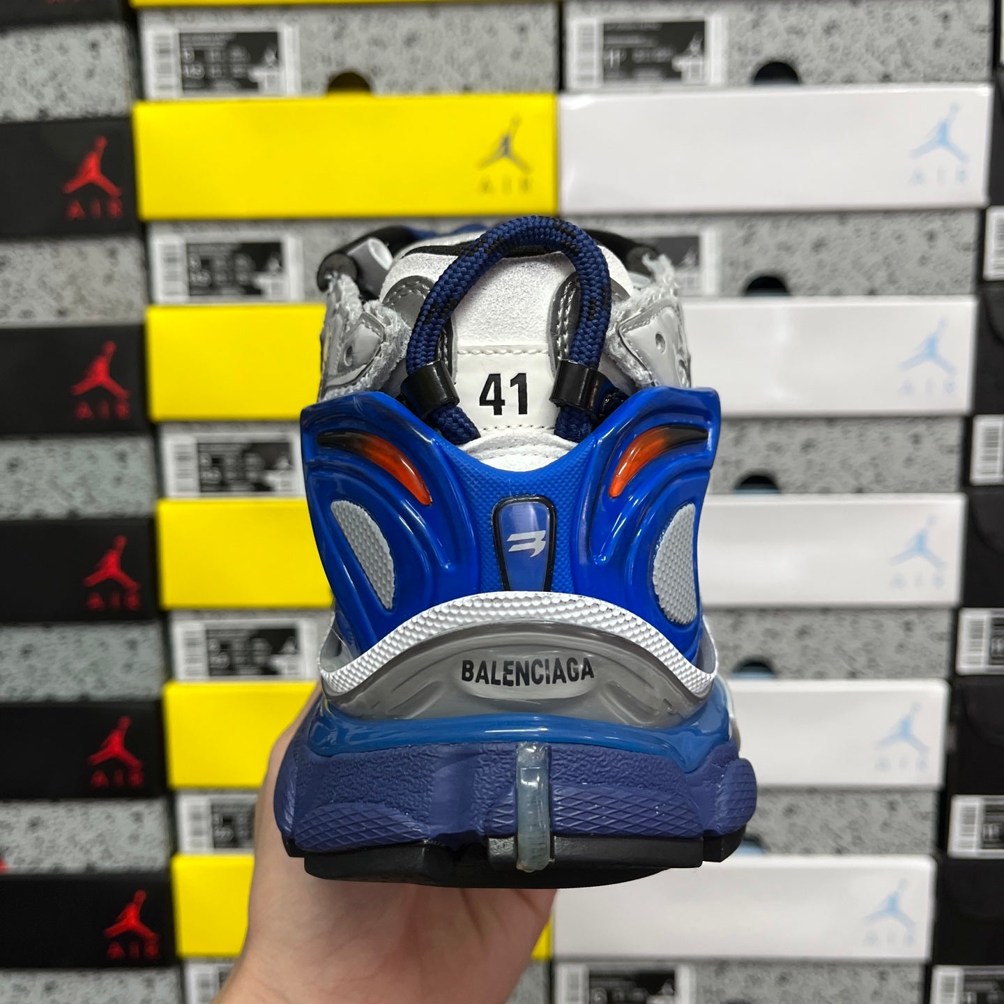 Unisex sneakers back view, blue heel cup and 'BALENCIAGA' logo on sole