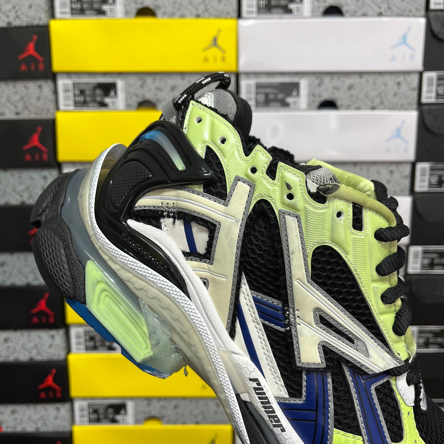 Balenciaga unisex running sneaker heel side: neon green panels, black mesh, and white detailing