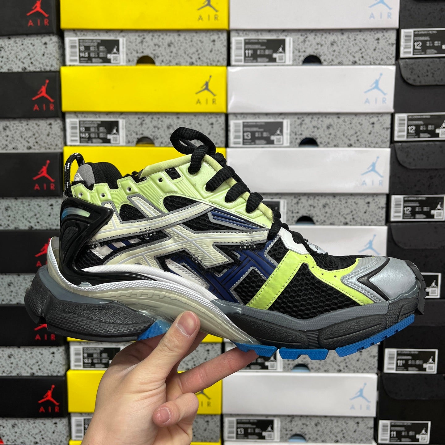 Balenciaga unisex running sneaker front three-quarter view in neon green and black with blue sole