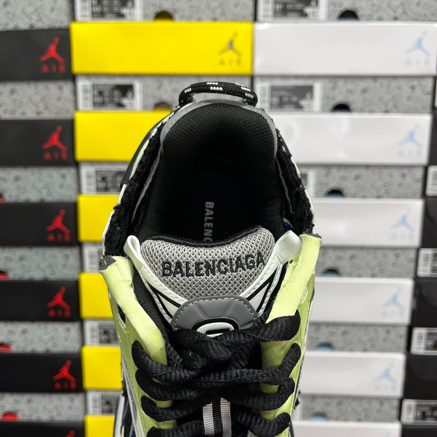 Balenciaga unisex running sneaker heel with black upper, neon green collar, and BALENCIAGA text
