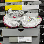 Silver lace-up sneaker with red heel stripe and green side detail, chunky sole.