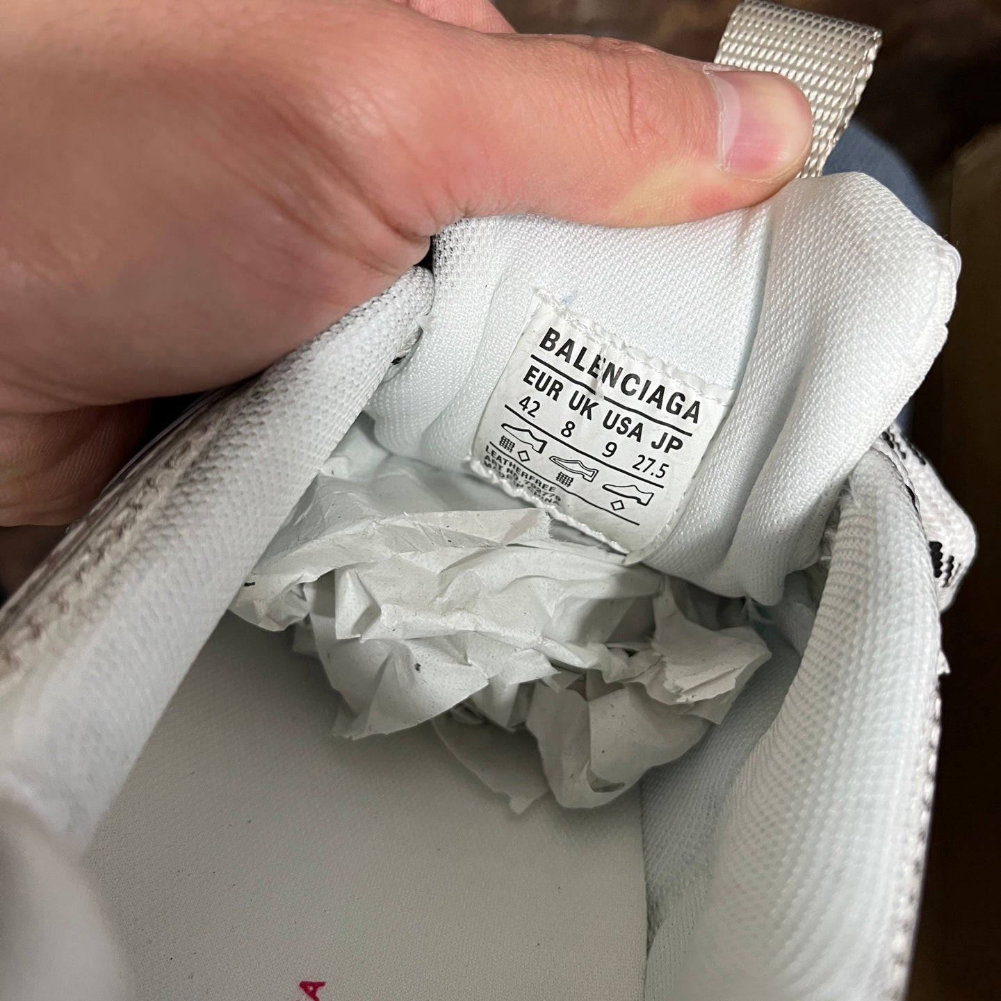 Balenciaga size label inside white sneaker collar, showing EU/UK/US sizing info.