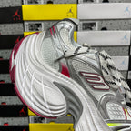 Silver mesh athletic sneaker with red accent stripe and patterned side overlays.