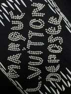 Louis Vuitton black T-shirt close-up of sparkling rhinestone lettering graphic