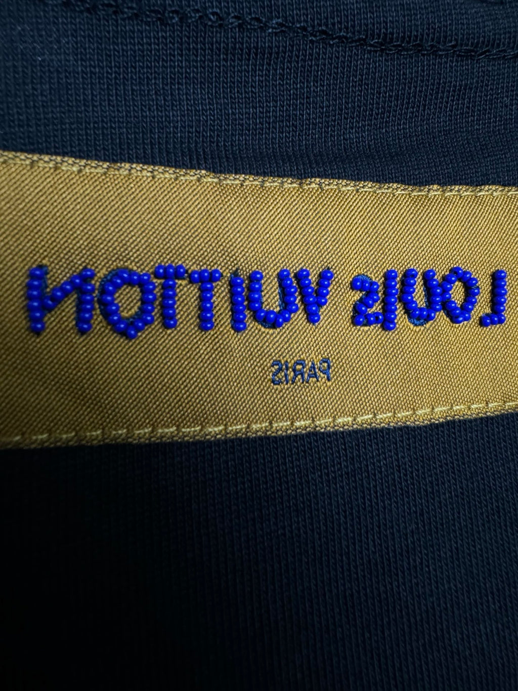 Louis Vuitton fabric label on black T-shirt interior neck hem