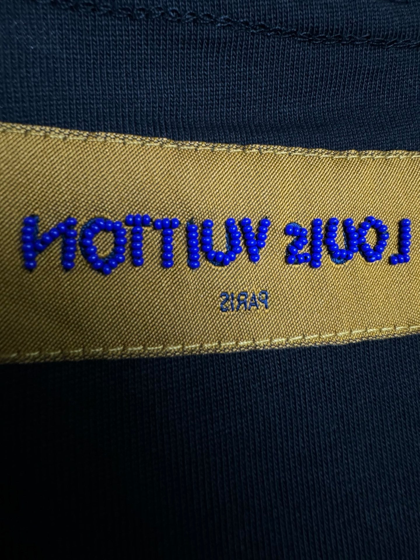 Louis Vuitton fabric label on black T-shirt interior neck hem