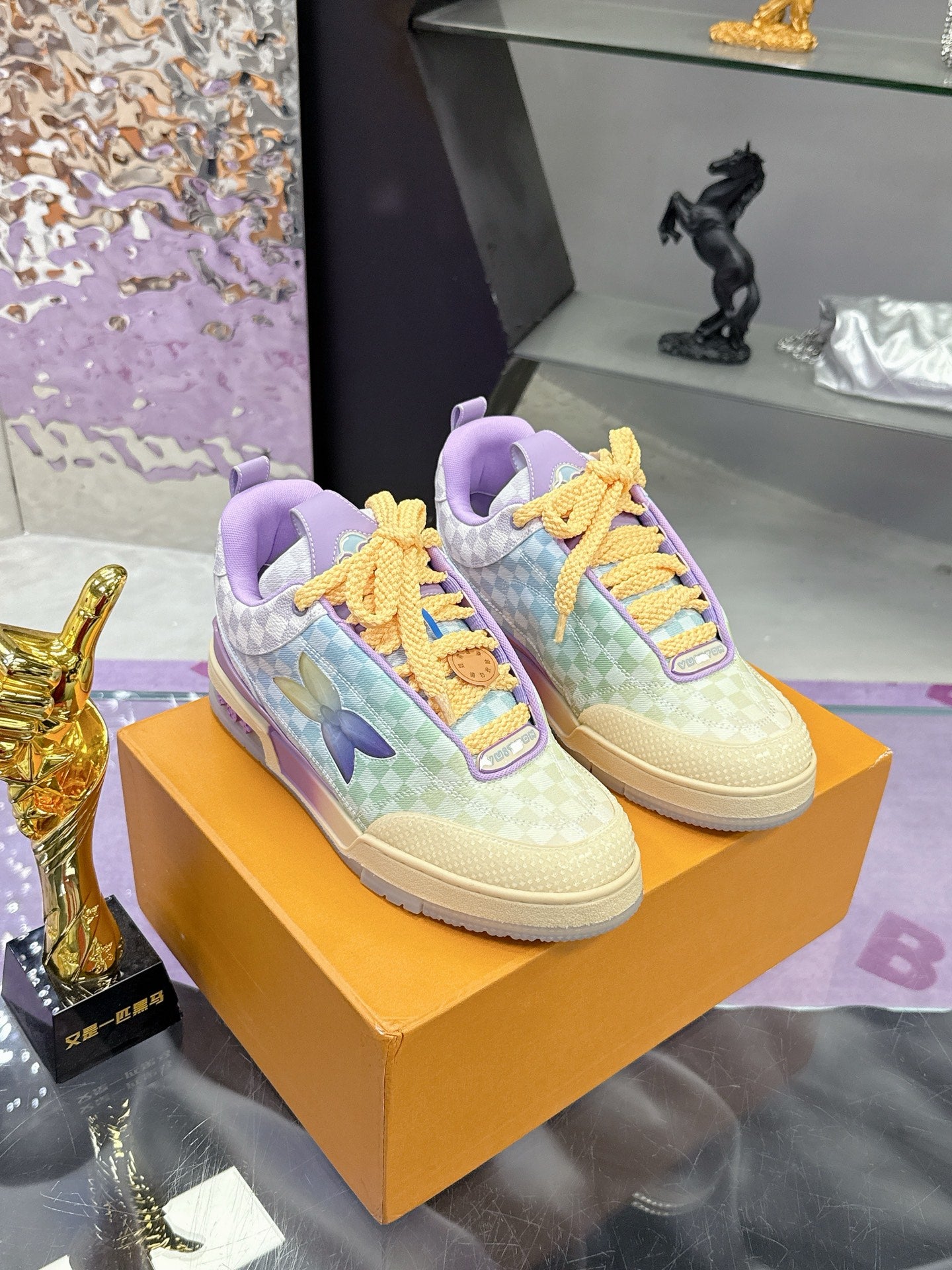 Louis Vuitton ladies sneakers on a box, pastel checkered pattern with yellow lace trim