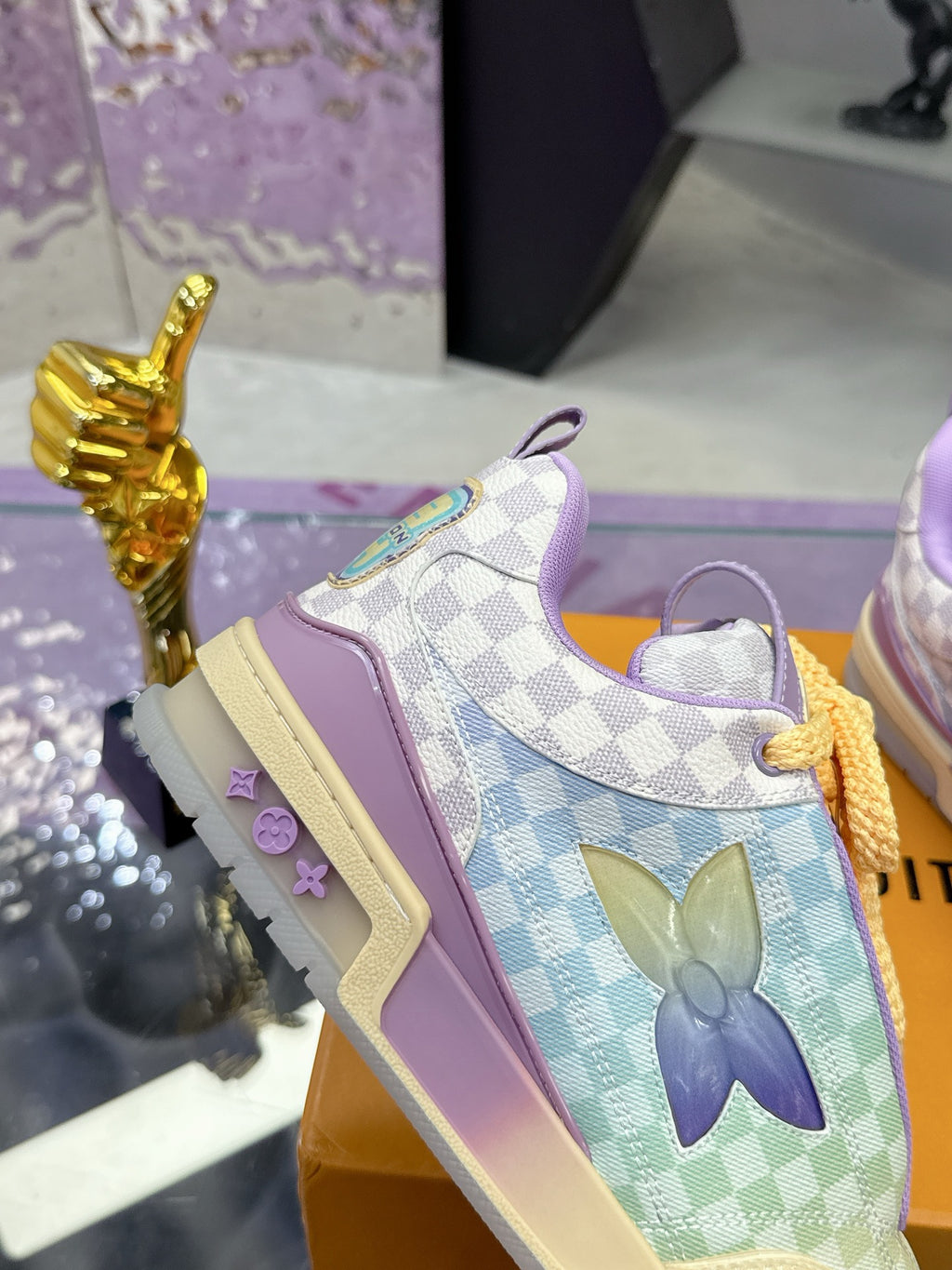 Louis Vuitton ladies sneakers, side view with purple panels, lavender collar, and checkered upper