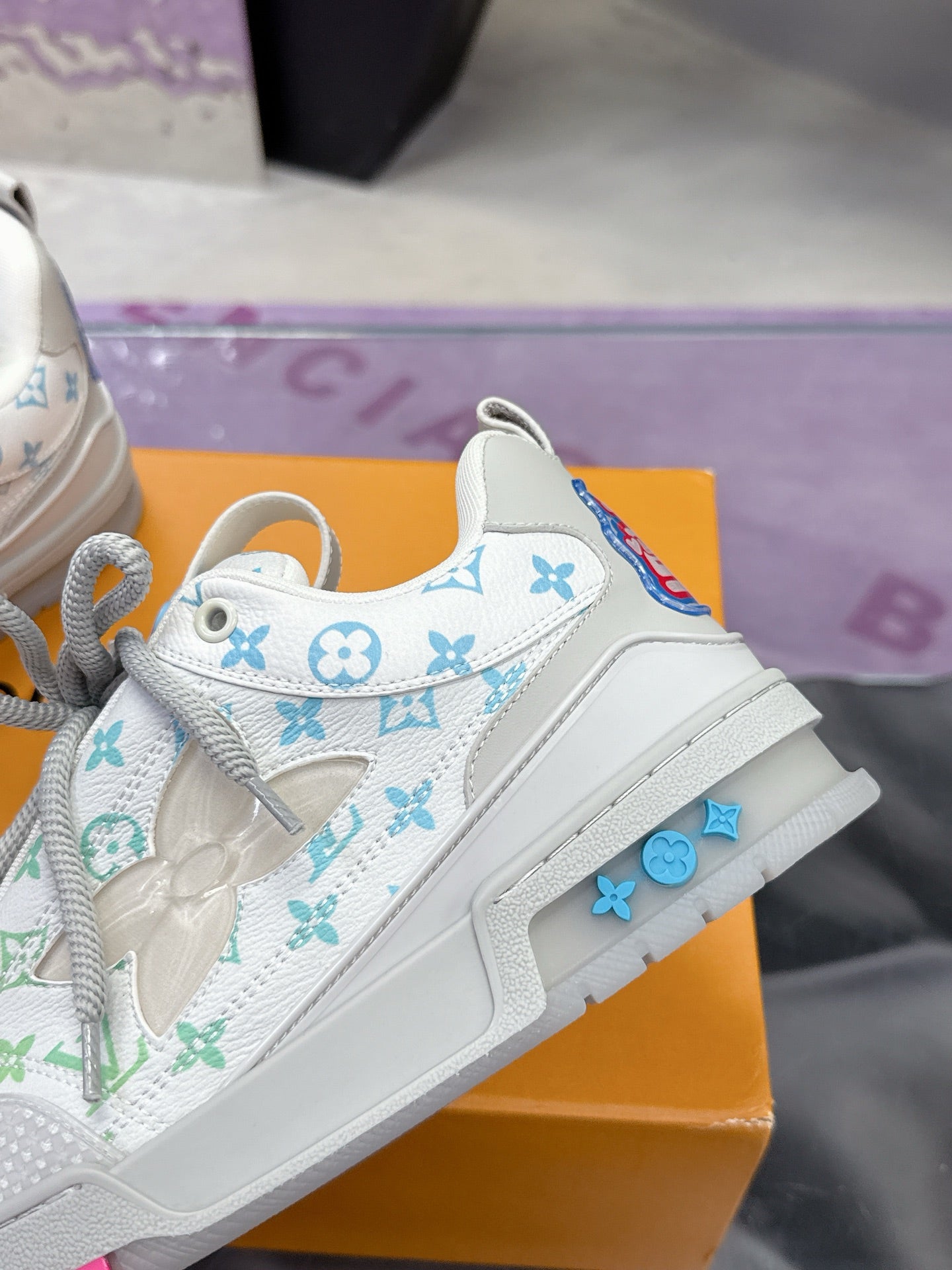 Louis Vuitton ladies sneaker side view, white with multicolor monogram print and chunky sole