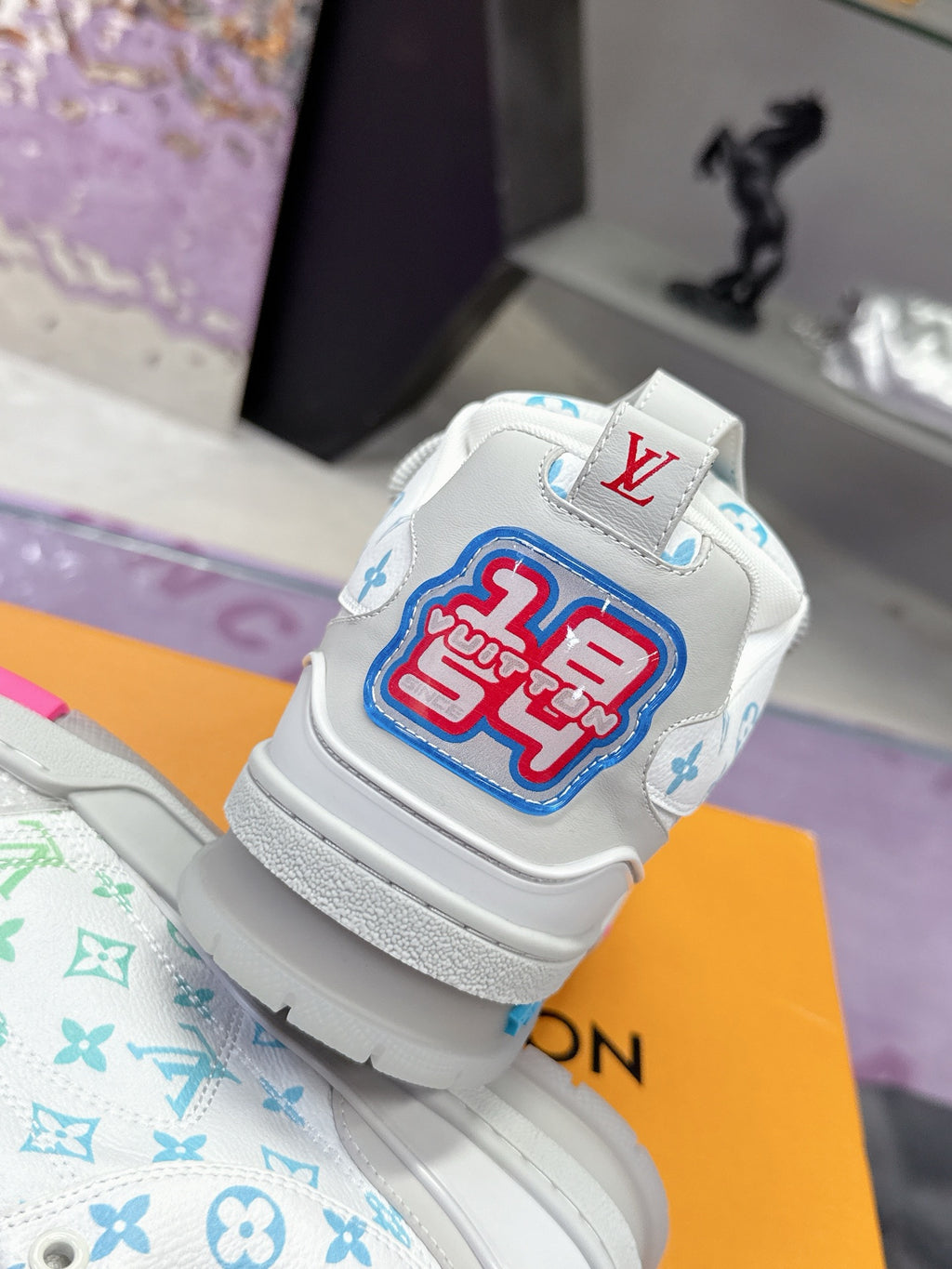 Louis Vuitton ladies sneaker back view, white with multicolor logo patch on heel