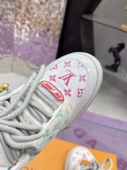 Louis Vuitton ladies sneaker close-up, white canvas with multicolor logo patch and laces