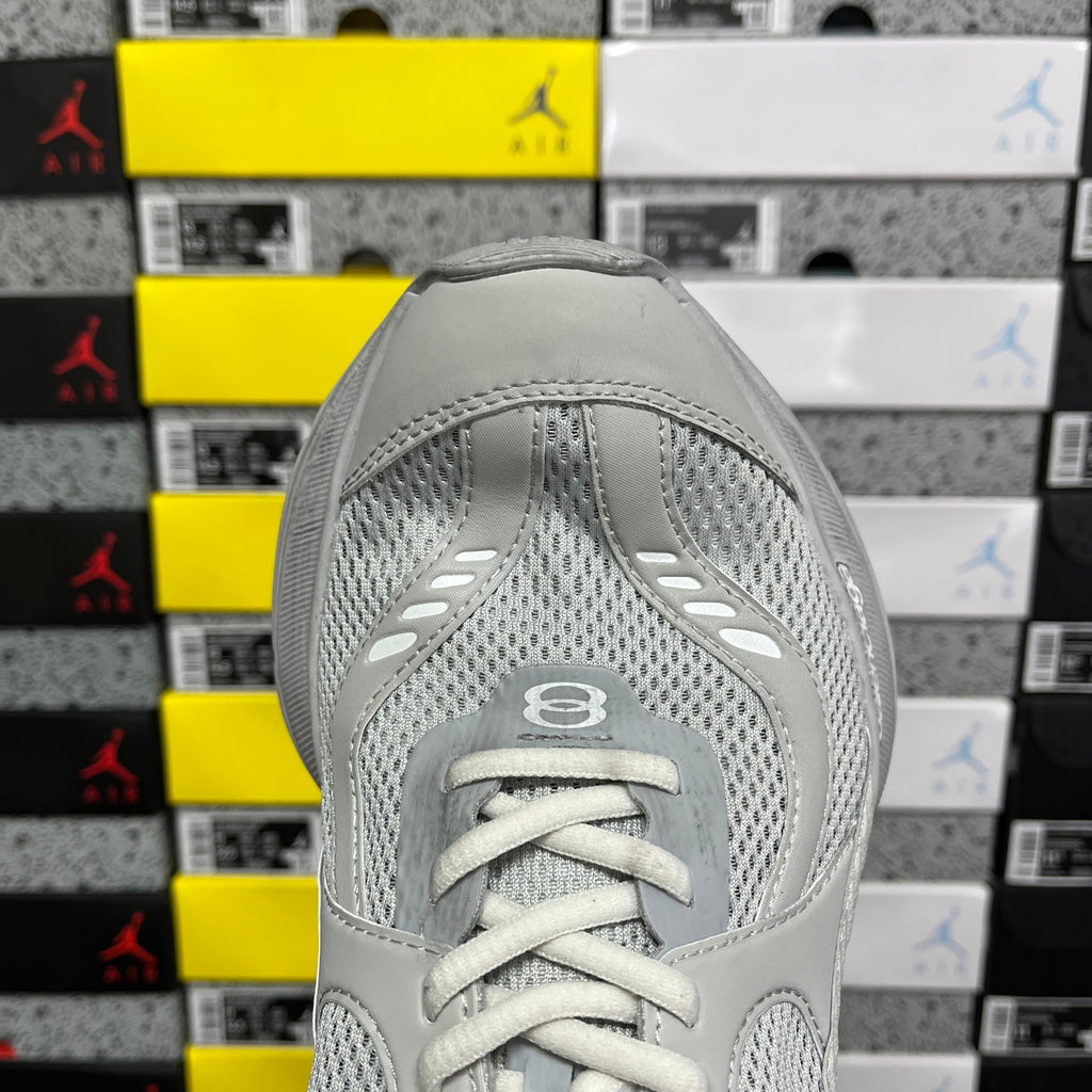 Light gray mesh sneaker toe with lace-up front and perforated panels