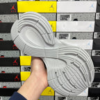 Light gray sneaker outsole with patterned tread and side logo mark