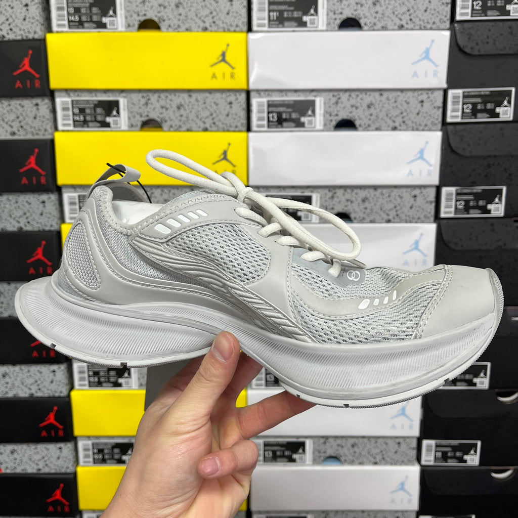 Light gray mesh sneaker with white laces and layered midsole