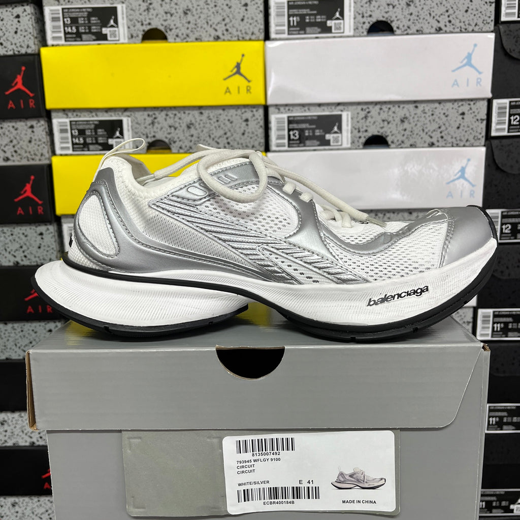 Silver/white lace-up mesh sneaker with Balenciaga logo and black outsole.