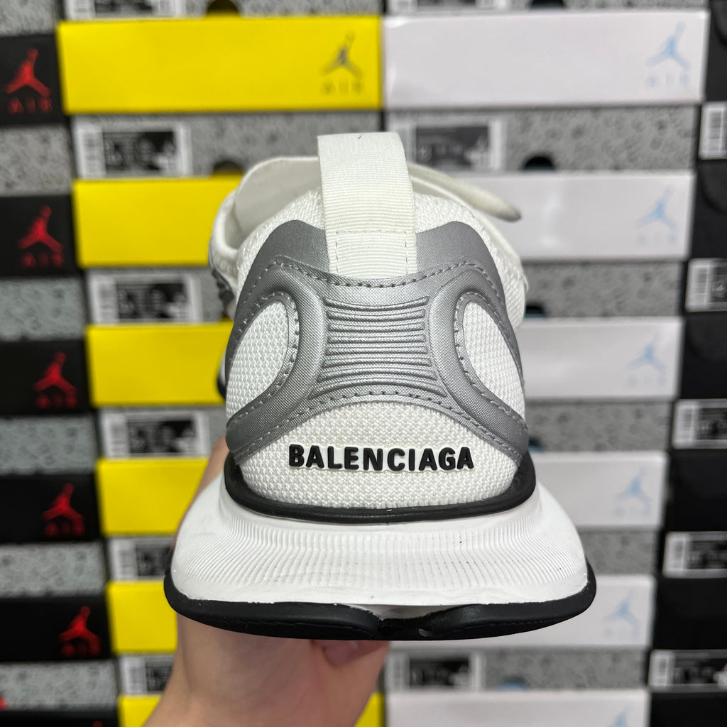 Silver and white sneaker heel with Balenciaga lettering and black sole edge.