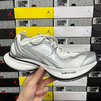 Silver and white mesh lace-up sneaker with chunky black outsole.