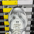 Silver and white lace-up sneaker with padded collar, front toe view.
