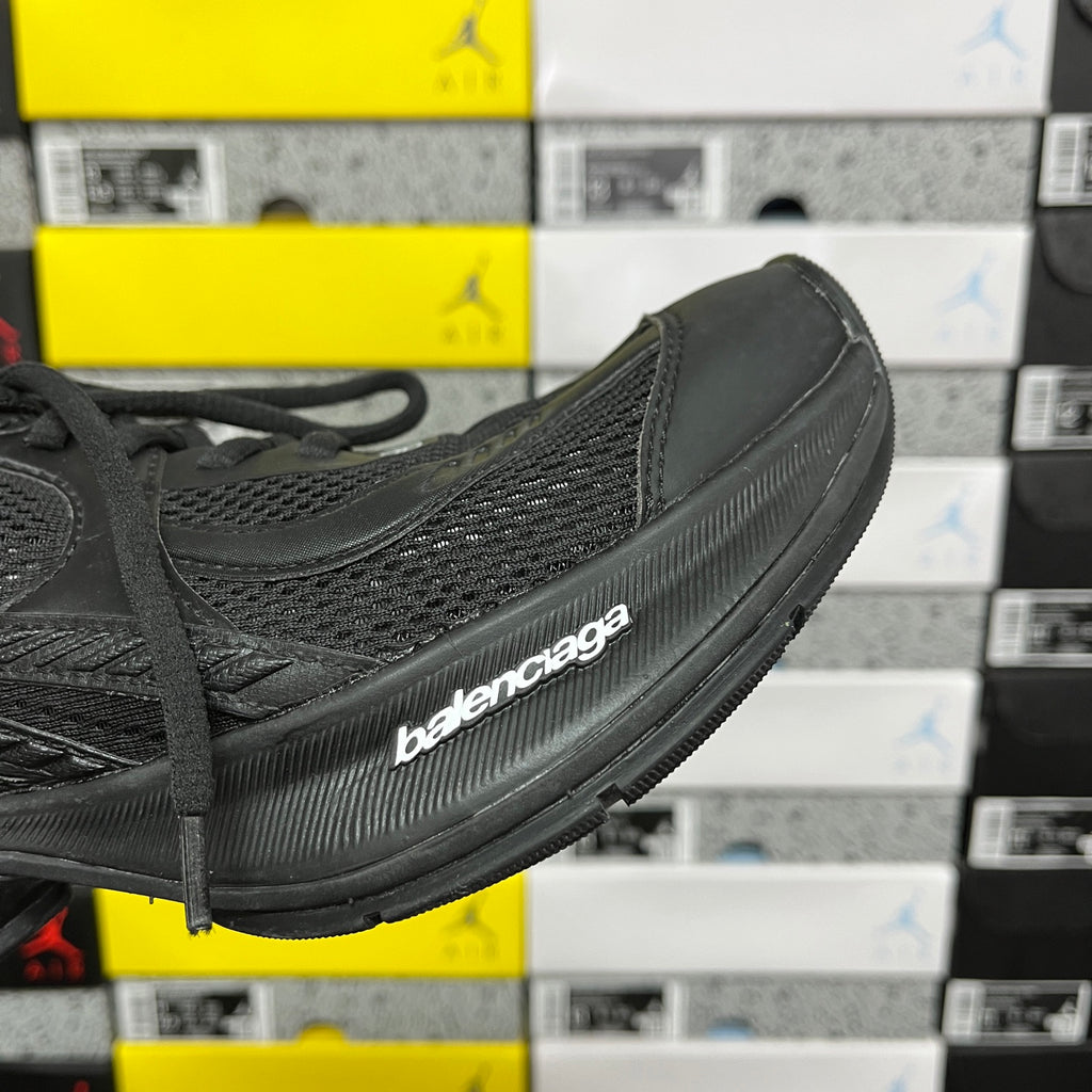 Black Balenciaga unisex sneaker, angled side with branded midsole and mesh texture
