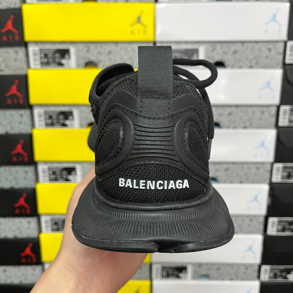 Black Balenciaga unisex sneaker, heel view with Balenciaga logo on back