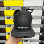 Black Balenciaga unisex sneaker, heel view with Balenciaga logo on back