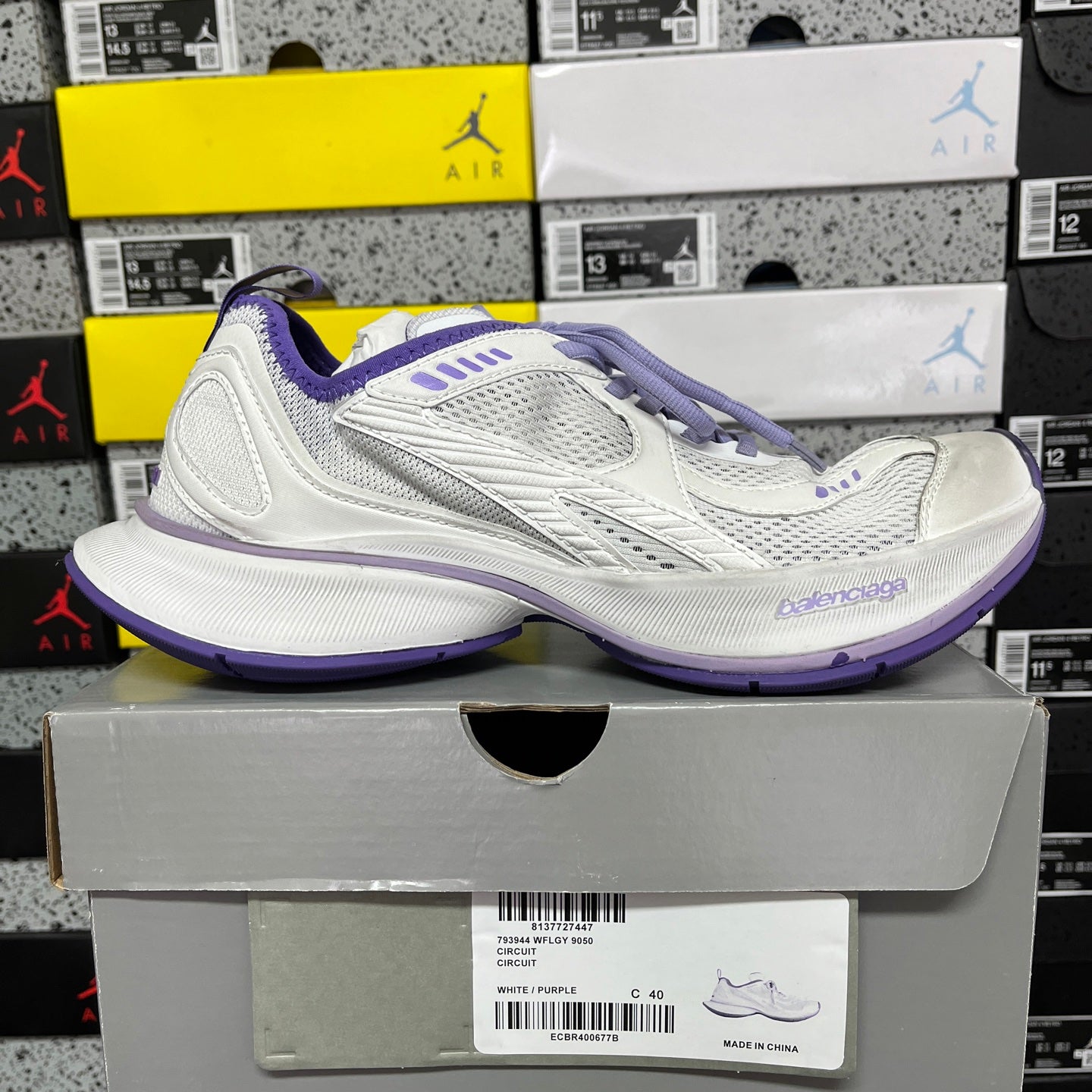 Unisex white sneaker with purple trim, front three-quarter view