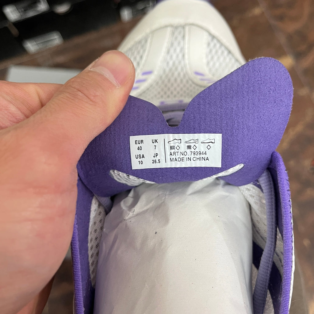 Unisex sneaker size label inside with purple fabric collar