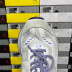 Unisex white sneaker with mesh panels and purple laced top