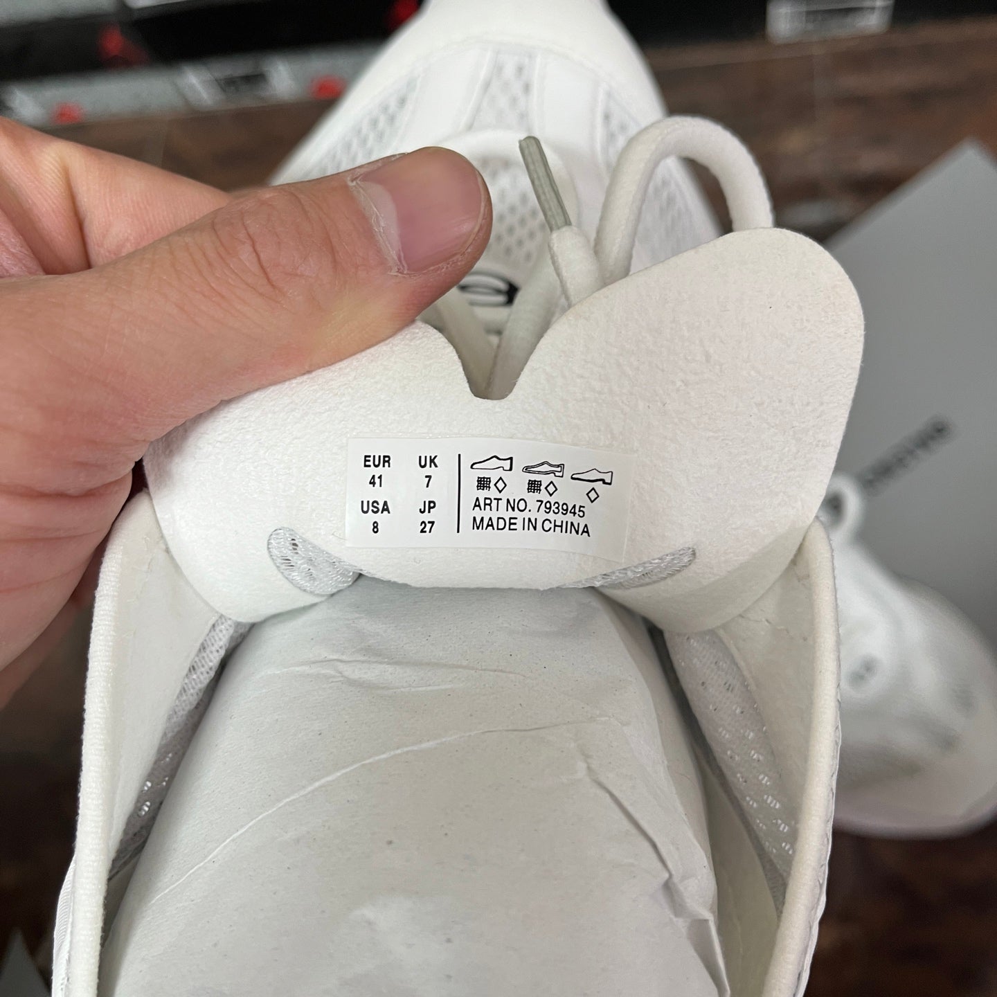 White sneaker inner size label: EU 41, UK 7, USA 8; made in China