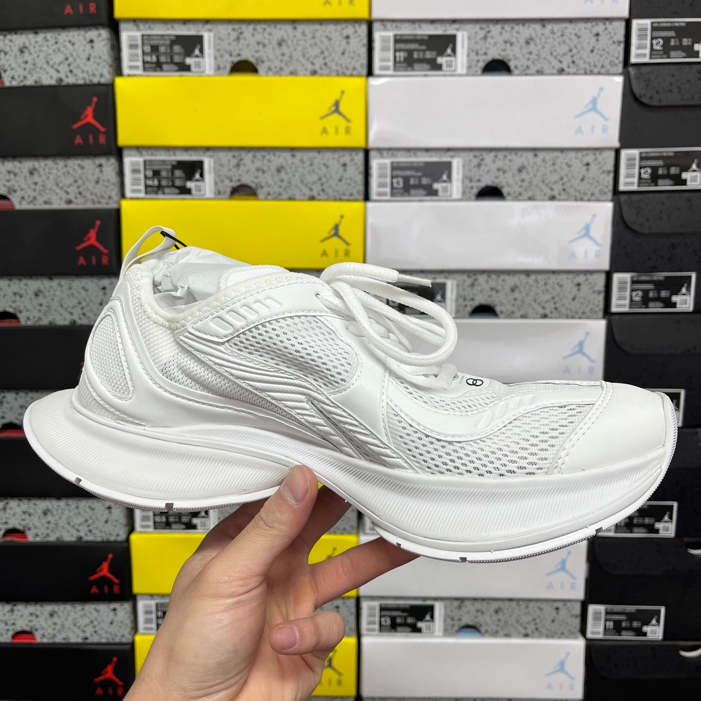 White lace-up Balenciaga sneaker from side view with cushioned midsole