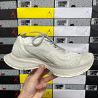 Off-white lace-up running shoe side view with textured knit upper and oval midsole