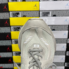 Off-white lace-up running shoe heel and toe with textured mesh upper