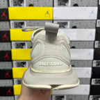 Off-white running shoe back view with fabric heel loop and BALENCIAGA logo