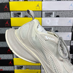 Off-white lace-up running shoe with padded collar and breathable mesh panels