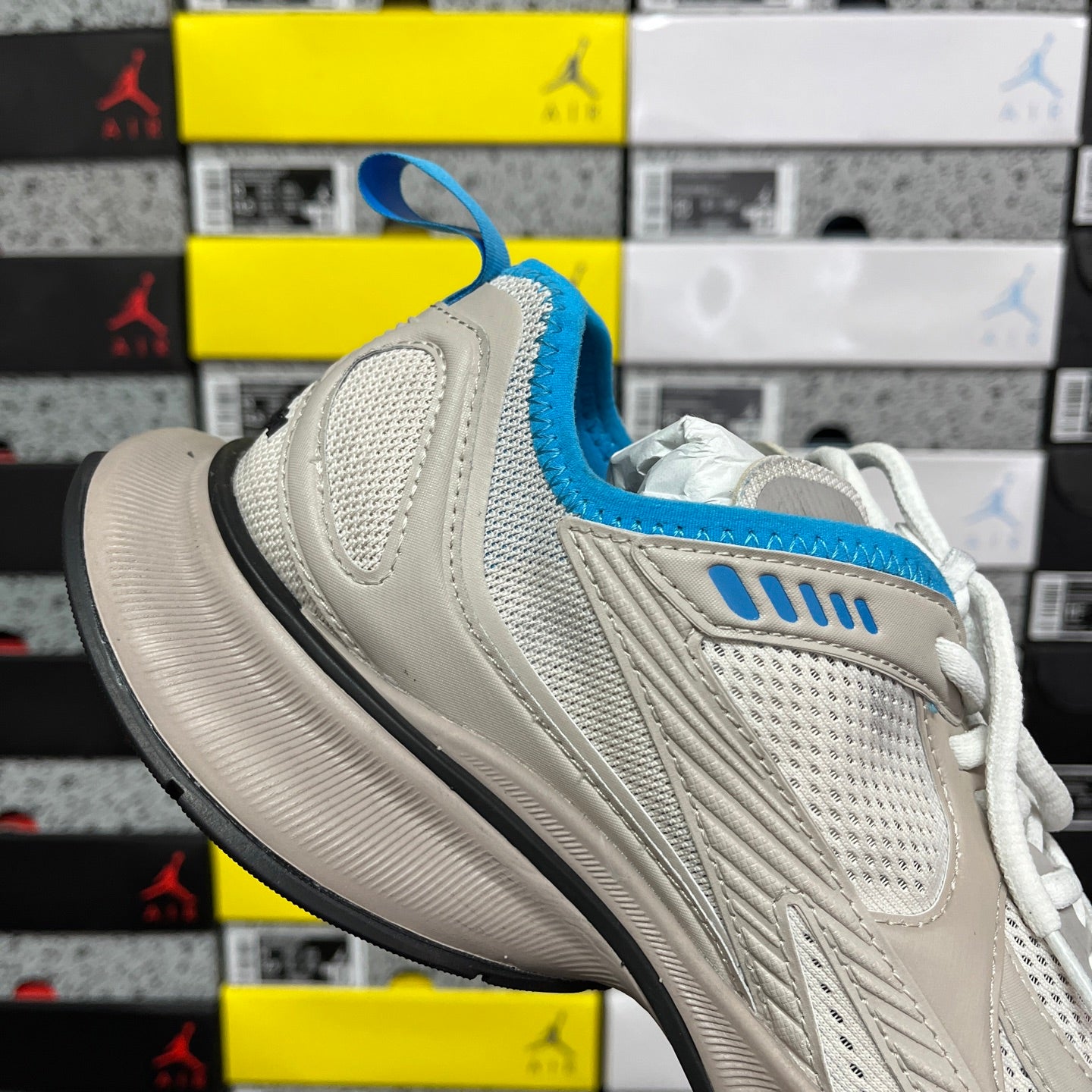 Balenciaga unisex sneakers in light beige with blue collar and white laces, side view