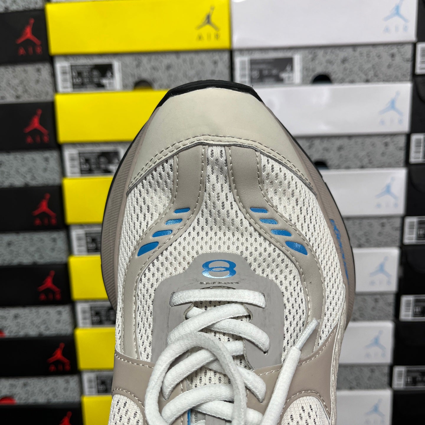 Balenciaga unisex sneakers in light beige with perforated toe and blue details, front view