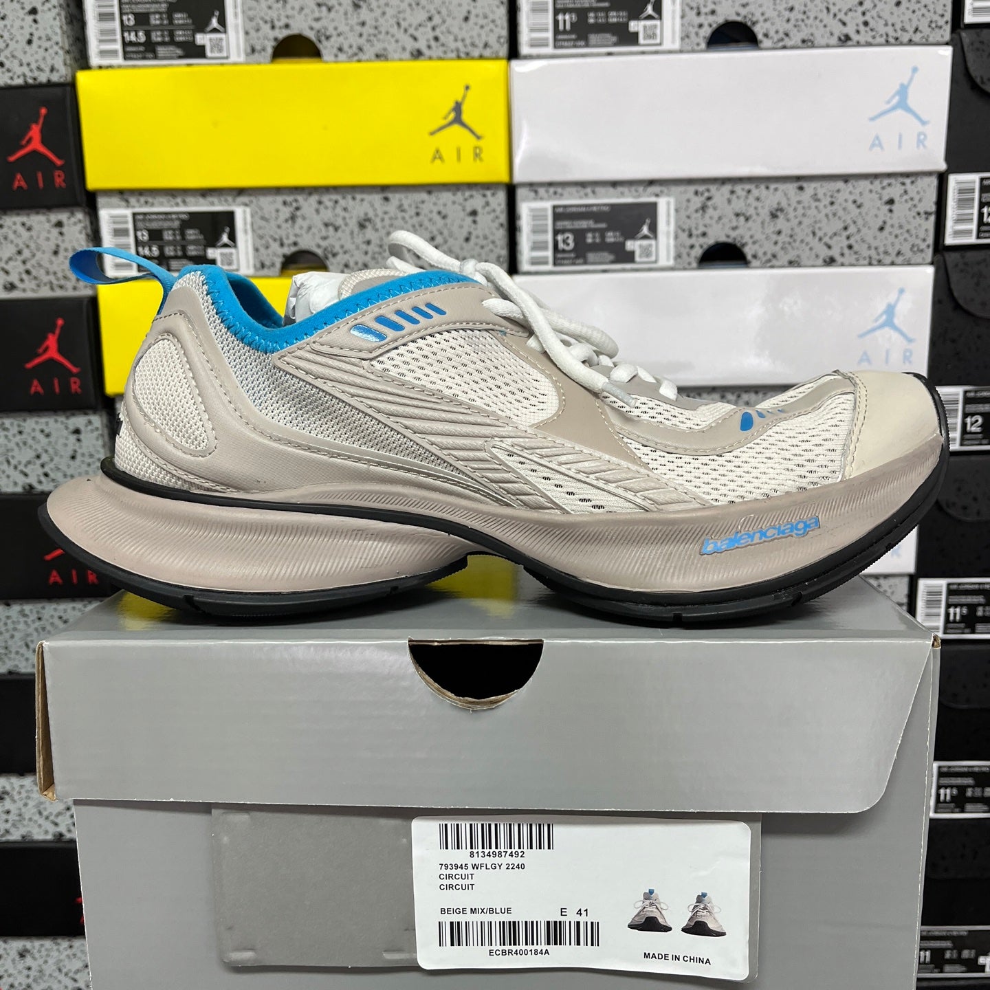 Balenciaga unisex sneakers in light beige with blue heel and white laces, side view