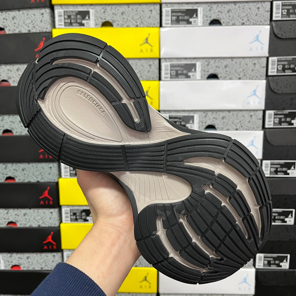 Balenciaga unisex sneakers outsole with textured black tread and beige midsole, bottom view