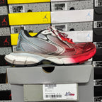 Red, gray, and silver Balenciaga runner sneaker side view with white-red laces