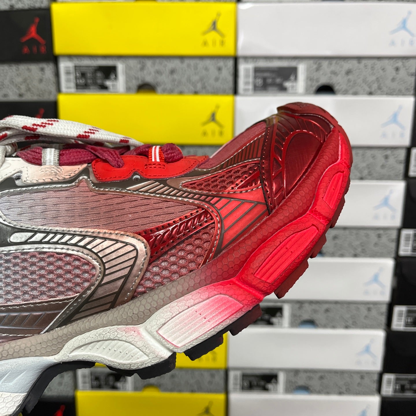 Red and gray Balenciaga runner sneaker side profile with mesh panels