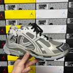 White and gray unisex sneakers with black laces and chunky layered midsole.