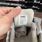Cream sneaker interior with fabric size label and printed sizing chart.