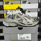 White and gray unisex sneakers with black laces and thick cushioned sole.