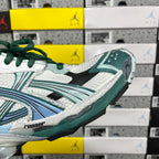 Runner sneaker side close-up with white mesh texture, teal trim, and green laces.